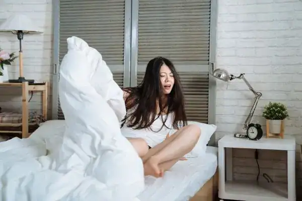 Image of woman getting up because of nighttime leaks UK